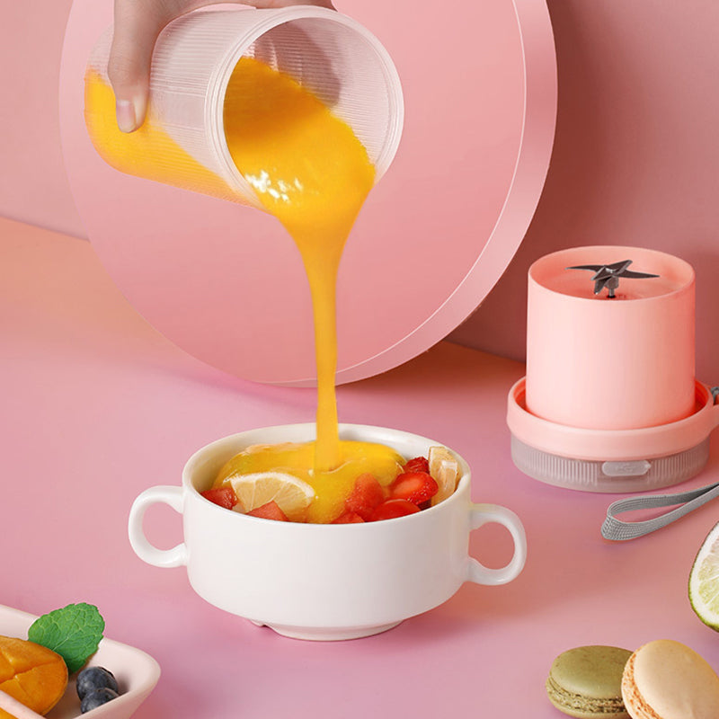 Portable USB blender pouring a fresh fruit smoothie into a bowl