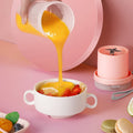 Portable USB blender pouring a fresh fruit smoothie into a bowl