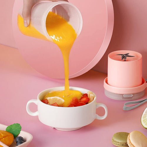 Portable USB blender pouring a fresh fruit smoothie into a bowl
