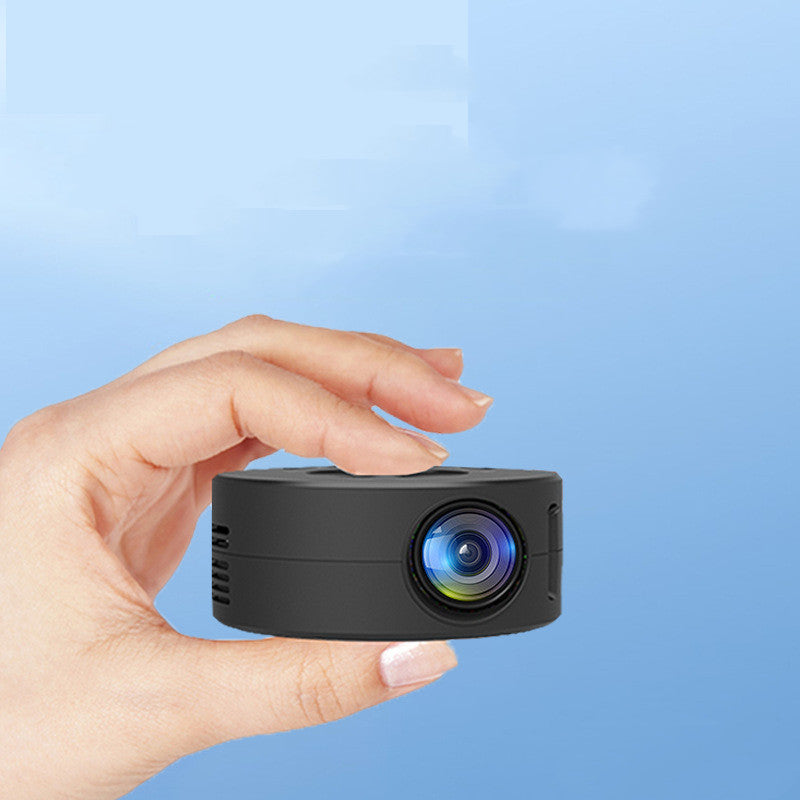 Palm-sized black pocket movie projector held in a hand