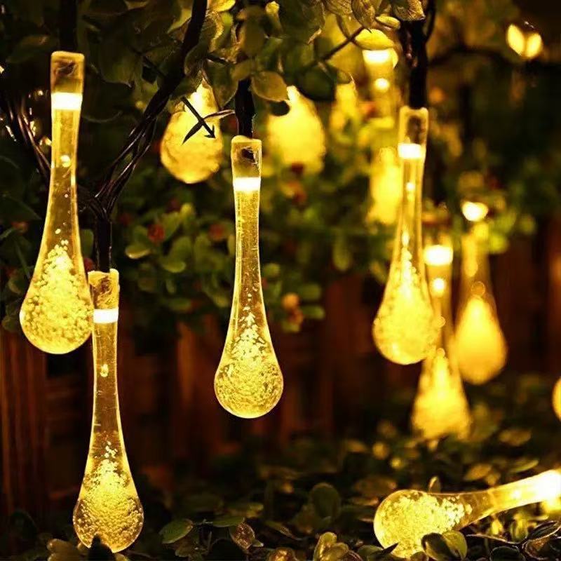 Warm white solar string lights glowing in a garden